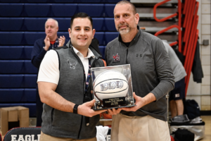Fred DiCarlo, left, celebrates his 300th career win with Eastchester Assistant Athletic Director Tom Puccini.